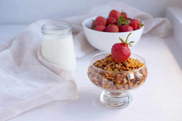 istock Homemade granola in jar on rustic kitchen table, healthy breakfa 927335556