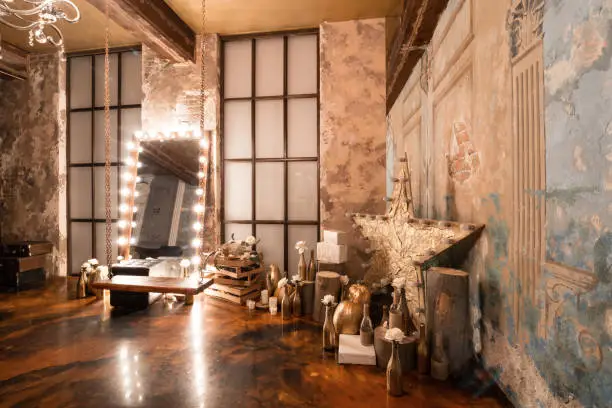 Photo of Loft interior with mirror, candles, brick wall, large window, living room, coffee table in modern design