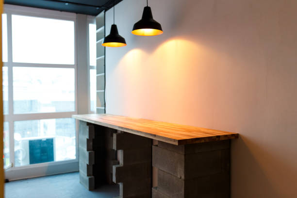 istock Office kitchen with wooden table and modern edison light. Minimalistic loft design 927346680