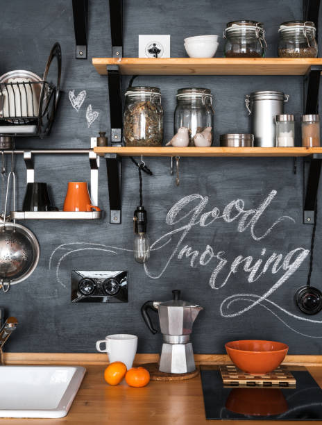 istock Design of modern kitchen in loft and rustic style. Wooden Shelves with different jars on a black wall with chalk 