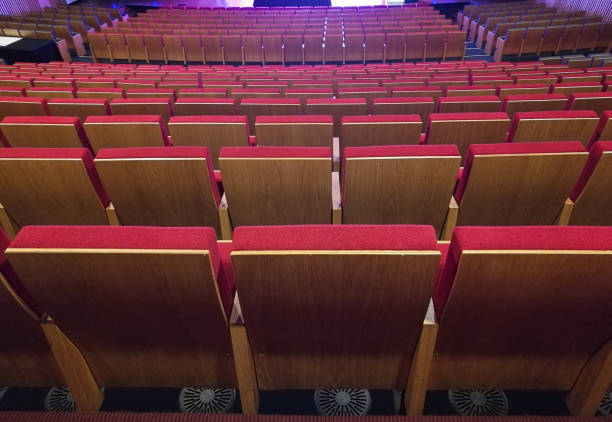 istock Red seats on a wide stage theater 927347392