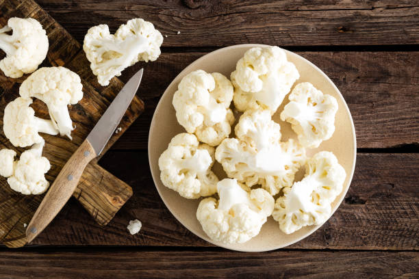 istock Fresh cauliflower on wooden board. Raw cauliflower. Top view 927352602