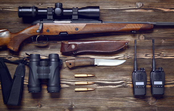 istock Hunting rifle and ammunition on a wooden background. 927358458