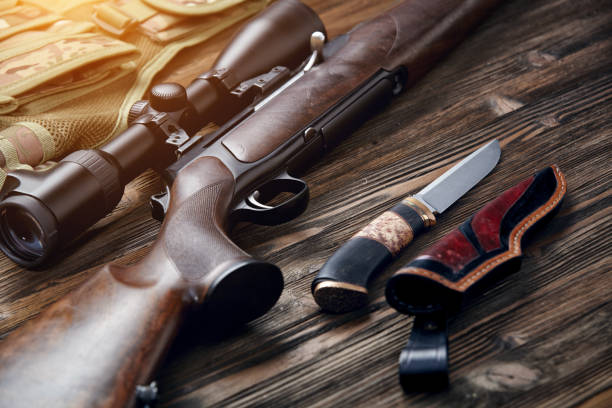 istock Hunting equipment on old wooden background. 927358468