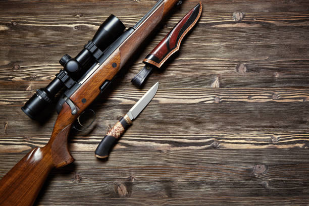istock Hunting equipment on old wooden background. 927358512