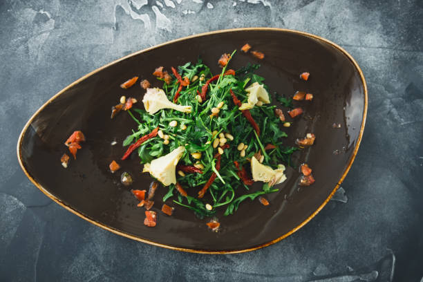 istock Vegetarian salad with mushrooms, pine nuts, pepper and tomatoes 927364076