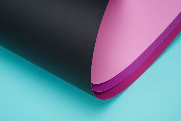 istock roll of black and pink paper on turquoise 927379620