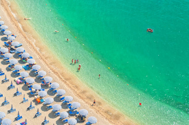 aerial view of beach with people aerial view of people relaxing on beach on hot summer day on Amalfi coat, Italy amalfi photos stock pictures, royalty-free photos & images