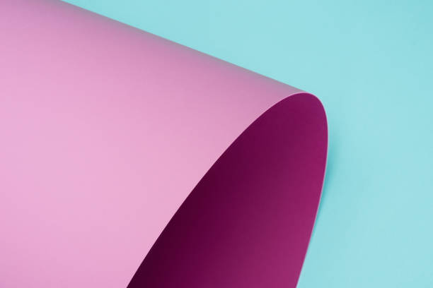 istock twisted pink paper isolated on turquoise 927380124