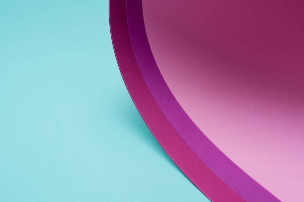 istock twisted pink and purple paper on turquoise 927380278