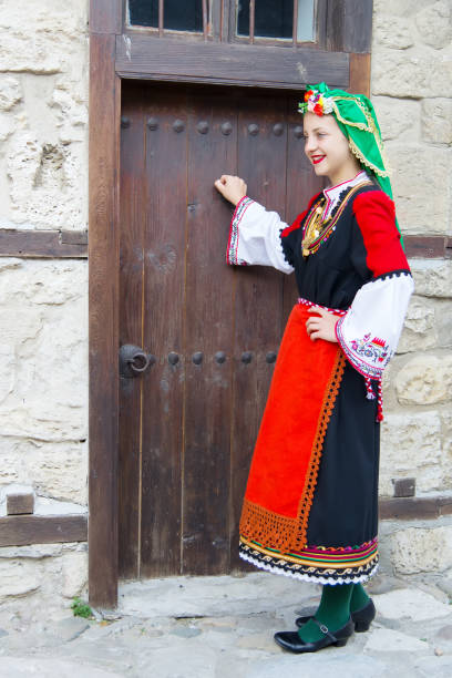 istock Folklore. Beautiful young people in folk costumes. 927380446