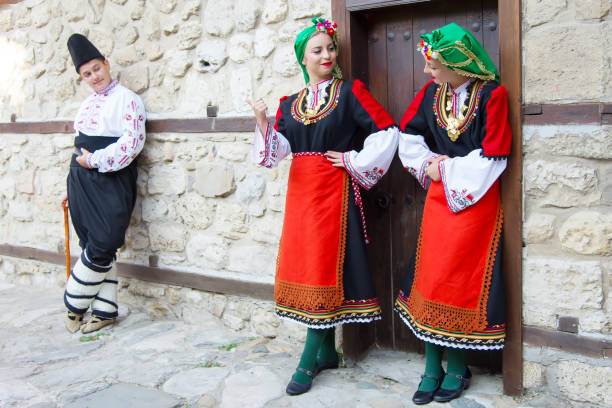 istock Folklore. Beautiful young people in folk costumes. 927383254