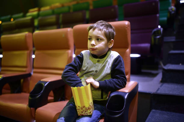istock Child eating popcorn in cinema 927386952