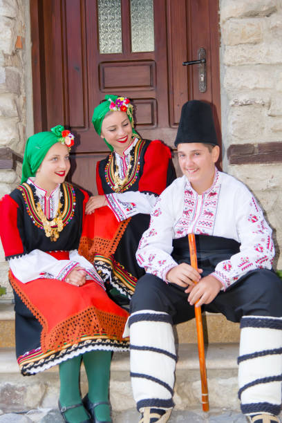 istock Folklore. Beautiful young people in folk costumes. 927387906