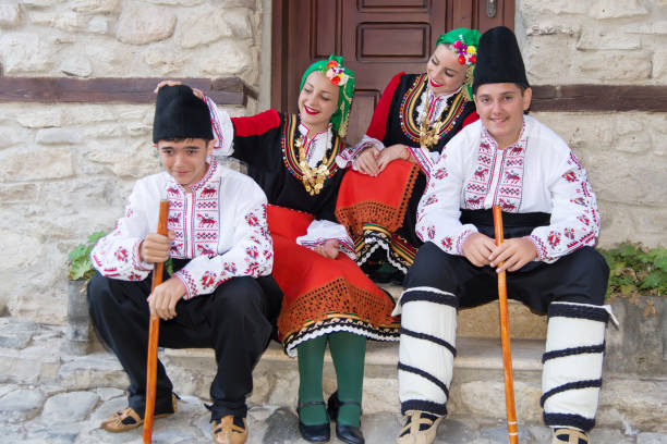 istock Folklore. Beautiful young people in folk costumes. 927388144