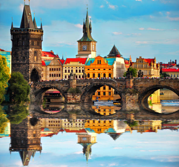Charles bridge in Prague Czech Republic. Beautiful view of famous bridge, colorful architecture and Vltava river with reflection,Europe