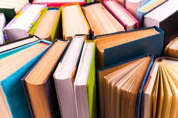 istock Open book, hardback books on bright colorful background. 927394094