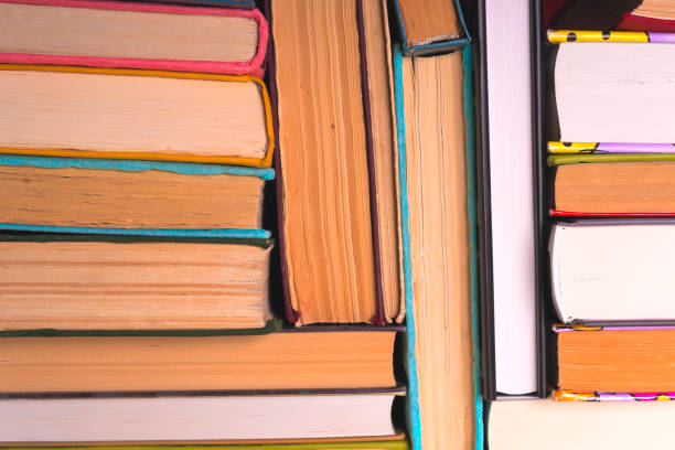 istock Open book, hardback books on bright colorful background. 927394134