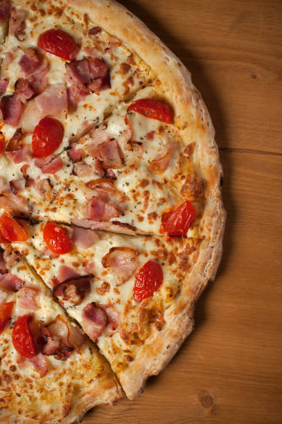 istock Fresh Italian pizza on wooden desk 927394294