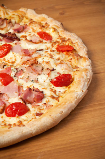 istock Fresh Italian pizza on wooden desk 927394478
