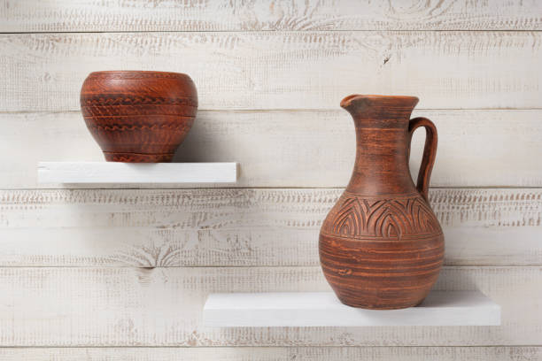 istock clay jug at shelf on white wooden background 927397670