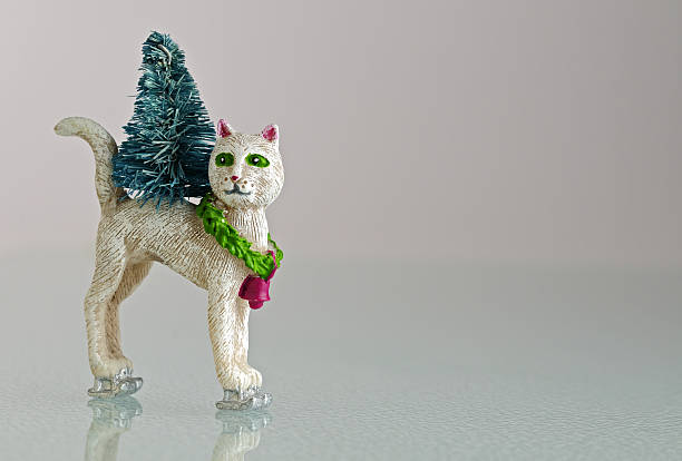 Fancy skating christmas cat figurine on ice