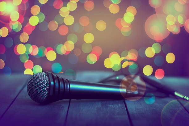 istock Microphone on a wooden table. Concept music, karaoke, 927402542
