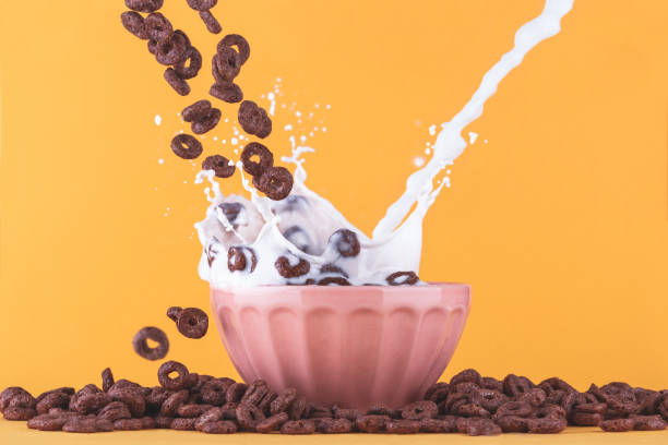 Milk cup with cereals and milk splashing