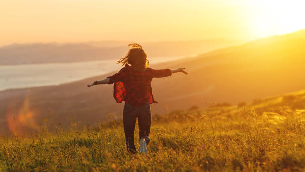 istock Happy woman   on sunset in nature iwith open hands 927402842