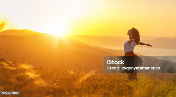 Happy Woman On Sunset In Nature Iwith Open Hands Stock Photo - Download Image Now - Women, Nature, Wellbeing