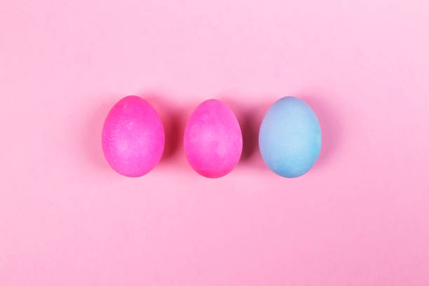 istock Pink and blue eggs on pink background. Top view 927403030