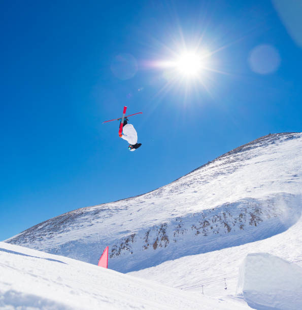 istock Skier doing high jumps in snowpark doing freestyle skiing day 927405824