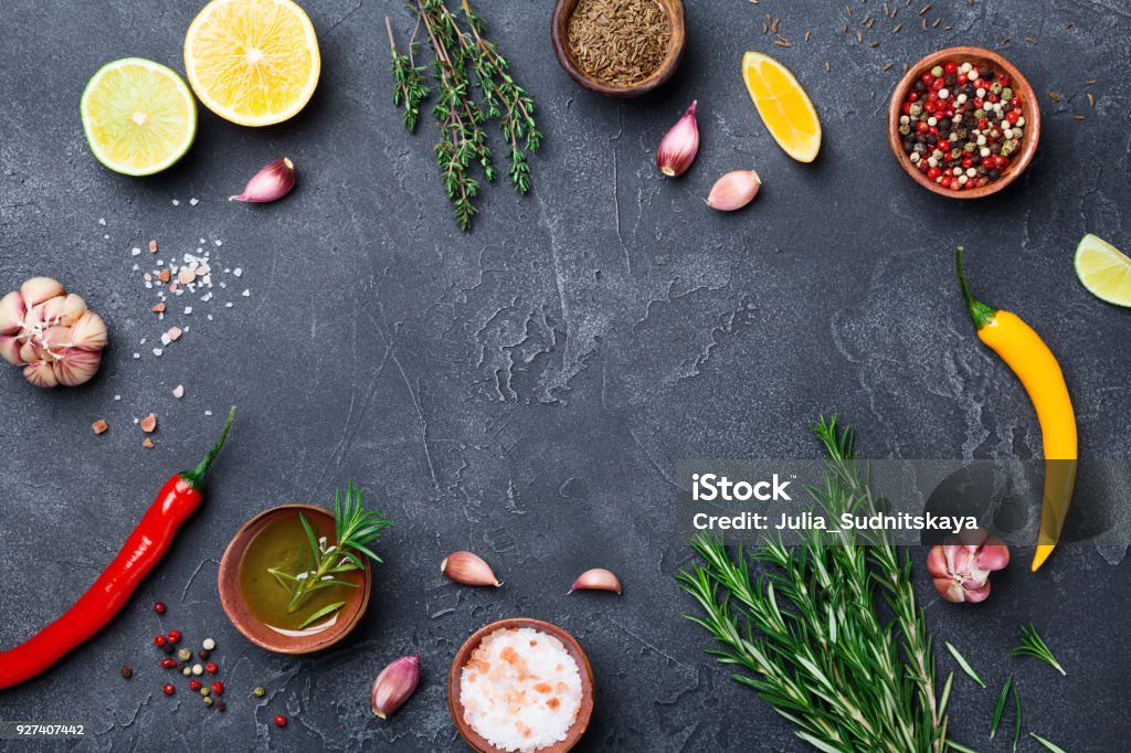 Mixed spices and herbs on black stone table top view. Ingredients for cooking. Food background. Mixed spices and herbs on black stone table top view. Ingredients for cooking. Food background. Copy space for text. Backgrounds Stock Photo