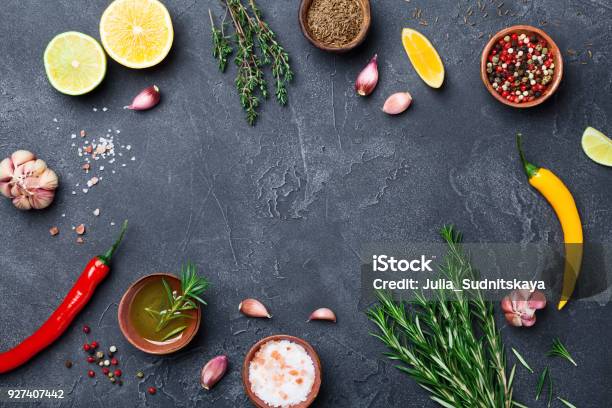 Mixed Spices And Herbs On Black Stone Table Top View Ingredients For Cooking Food Background Stock Photo - Download Image Now