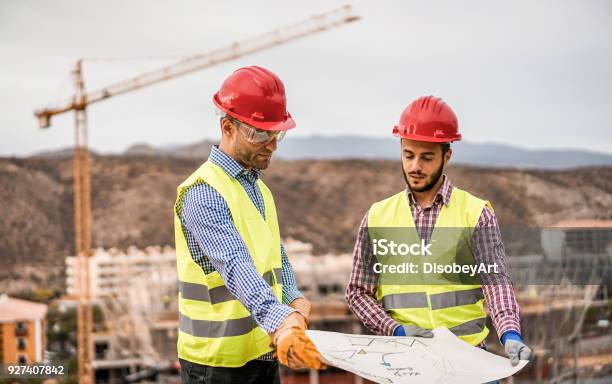 Builders On Residential Construction Site Looking The Building Project Workers Are Satisfied Of Their Plan Dealing Real Estate Engineer And Industrial Concept Focus On Left Man Face Stock Photo - Download Image Now