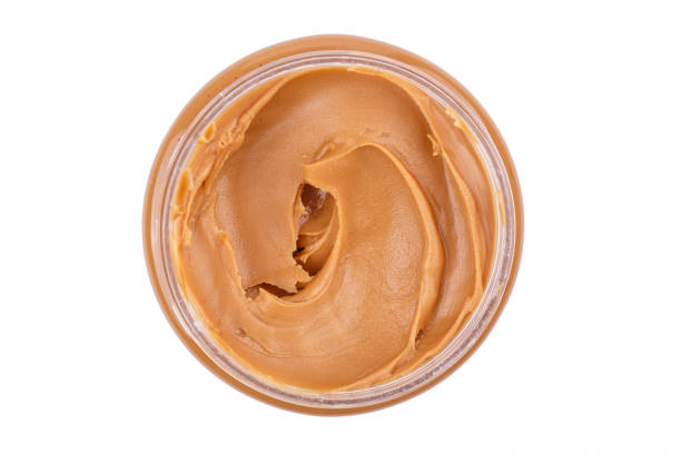istock peanut butter in a plate, isolated on a white background 927410572