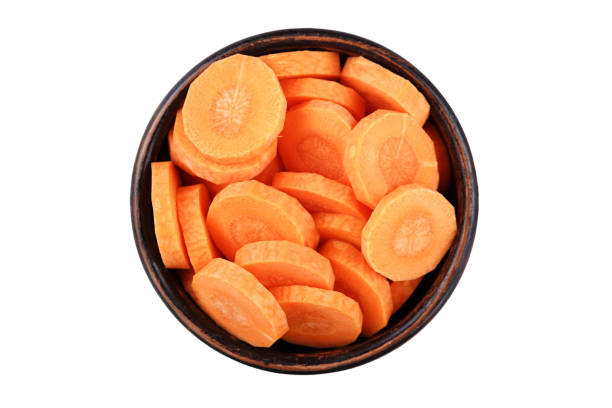 istock sliced fresh carrots, isolated, in a plate 927410960