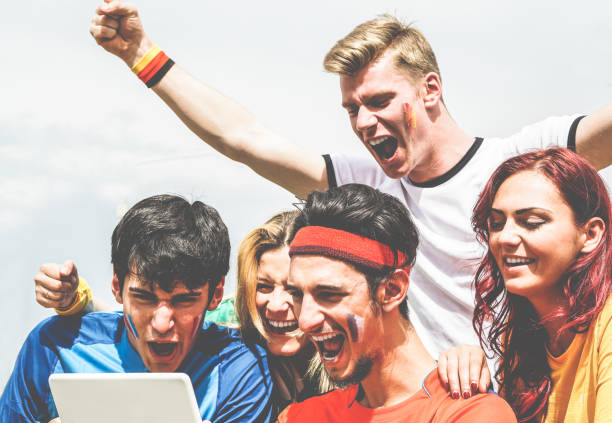 istock Happy supporters from different countries watching football sport on notepad tablet computer - Main focus on center bottom man - Crazy fan celebrating a goal in world soccer game - Gathering concept 927411160