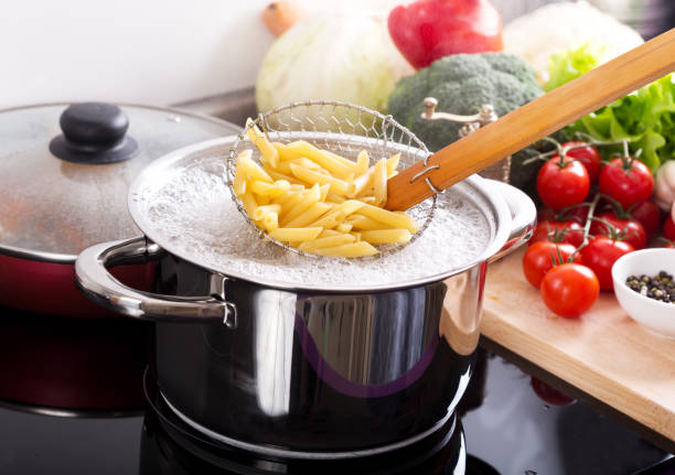 istock Cooking pasta in a pot with boiling water on a cooker 927414868