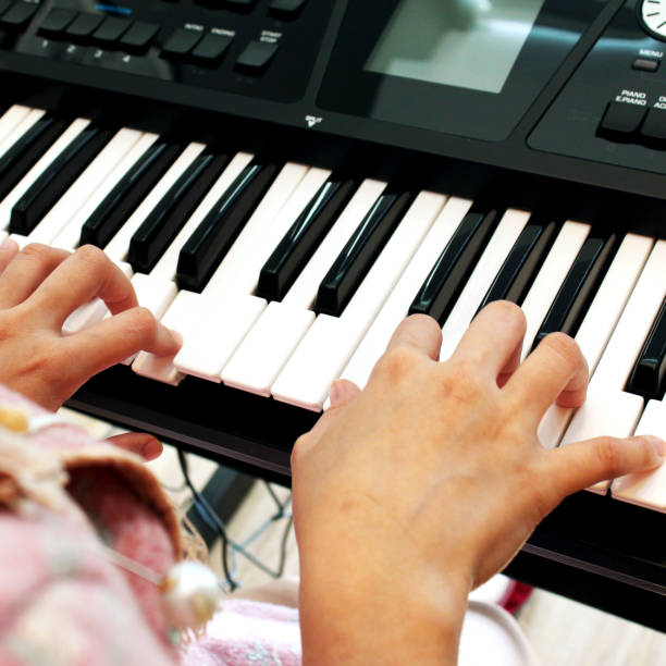 istock beautiful hand playing keyboard of the piano foreground. 927414894