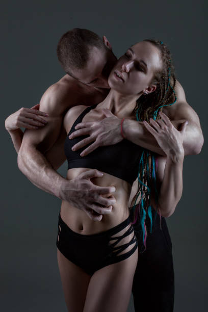 Man is hugging a woman.