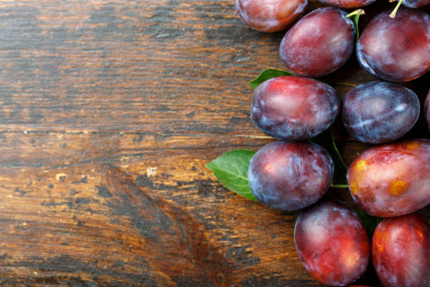 istock ripe plums on a wooden background 927418430