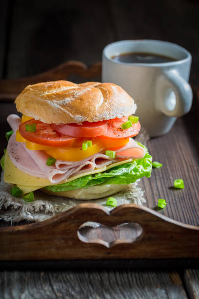 istock Tasty sandwich with ham, cheese and tomatoes 927422932
