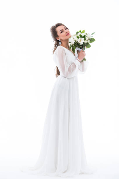 istock dreamy bride posing in dress with wedding bouquet, isolated on white 927423868
