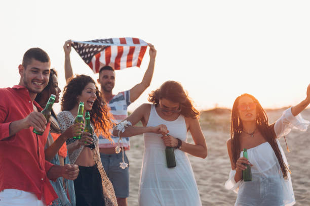 istock Hipster  friends at beach on sunset 927426716