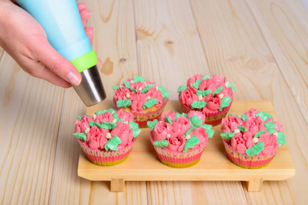 cupcakes with cream on wooden background
