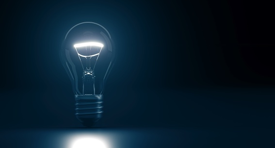3D Rendering Of Classic Glass Light Bulb With Glow On Dark Background With Empty Space