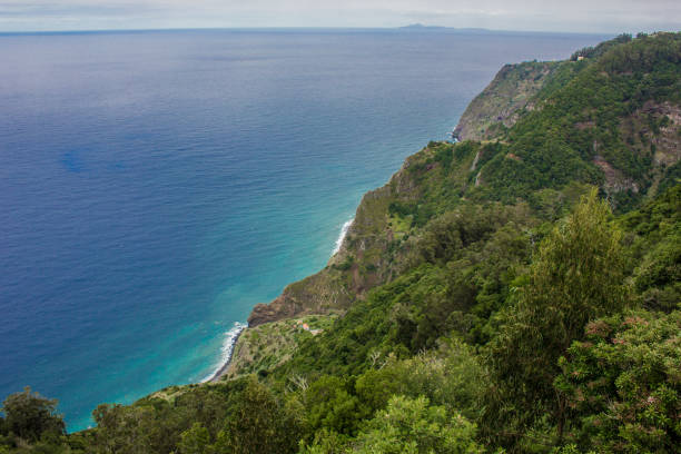 istock Coastline of Madeira with high cliffs along the Atlantic Ocean. blue sky 927436662