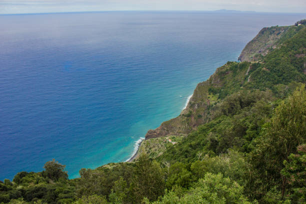istock Coastline of Madeira with high cliffs along the Atlantic Ocean. blue sky 927436680