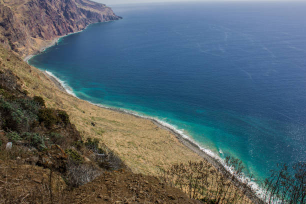 istock Coastline of Madeira with high cliffs along the Atlantic Ocean. blue sky 927437020
